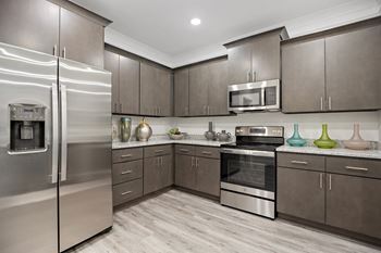A kitchen with stainless steel appliances and wooden cabinets